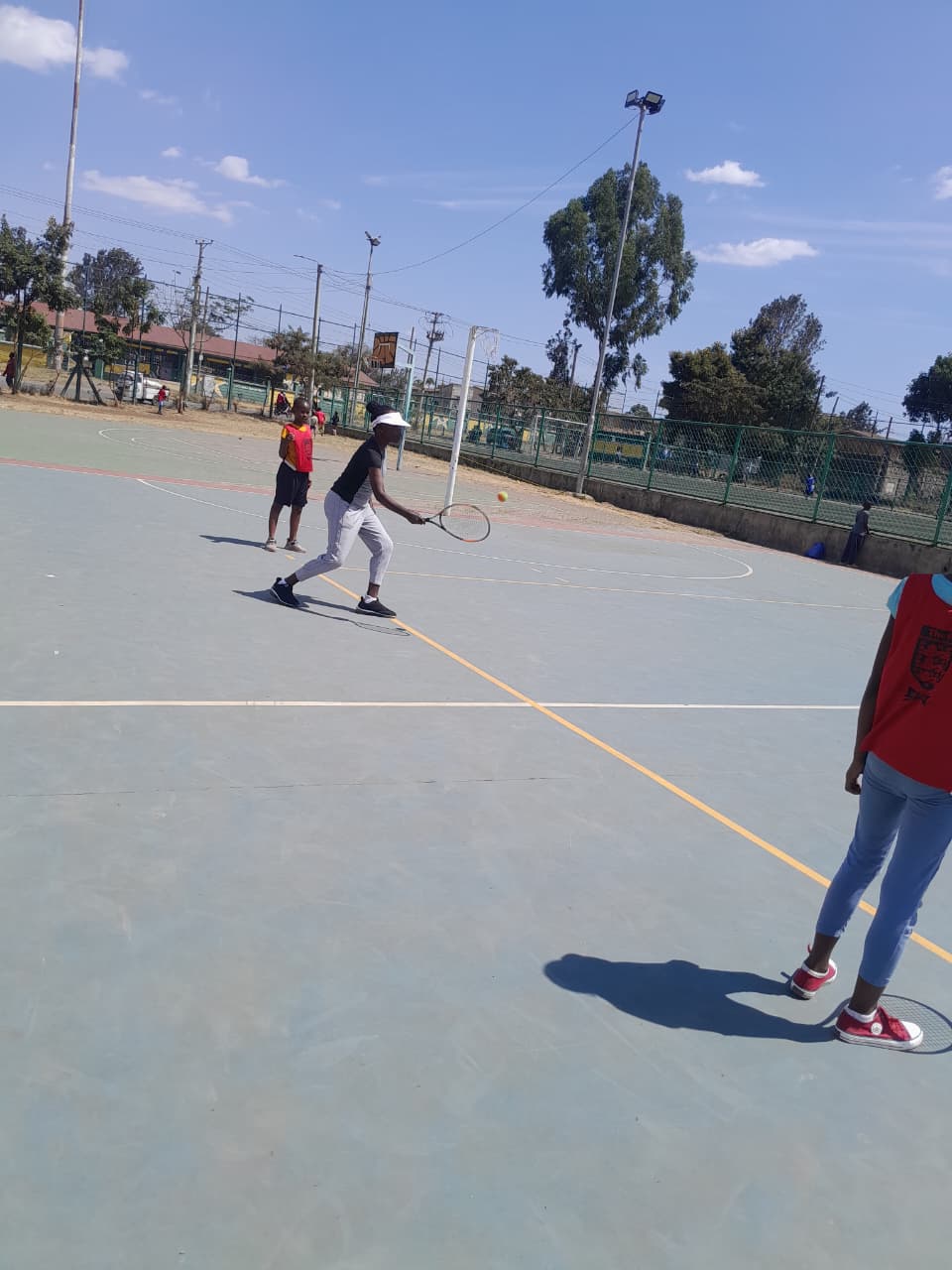 Young player practising tennis at Ayola's Tennis Academy