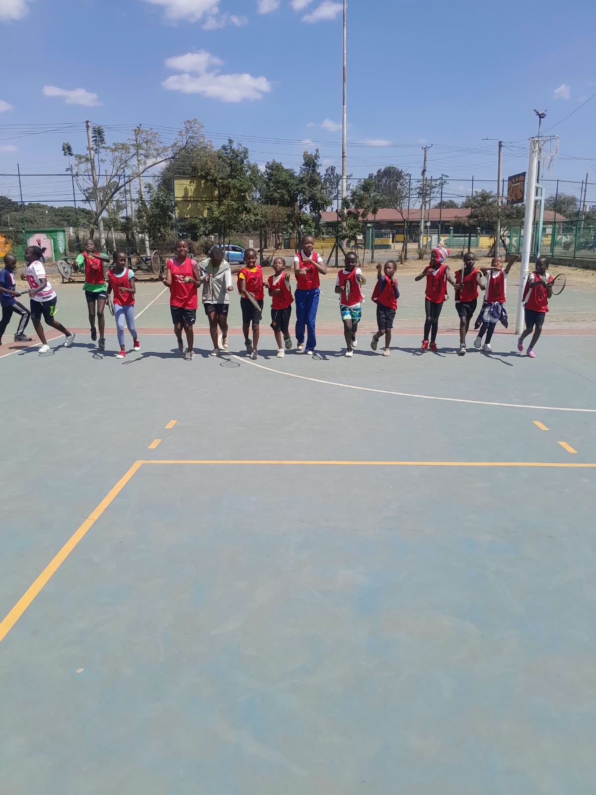 Young players moving together during a tennis session